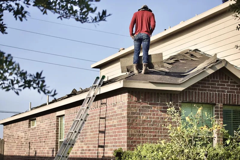 Professional roofer working on a residential roof in Porchtown